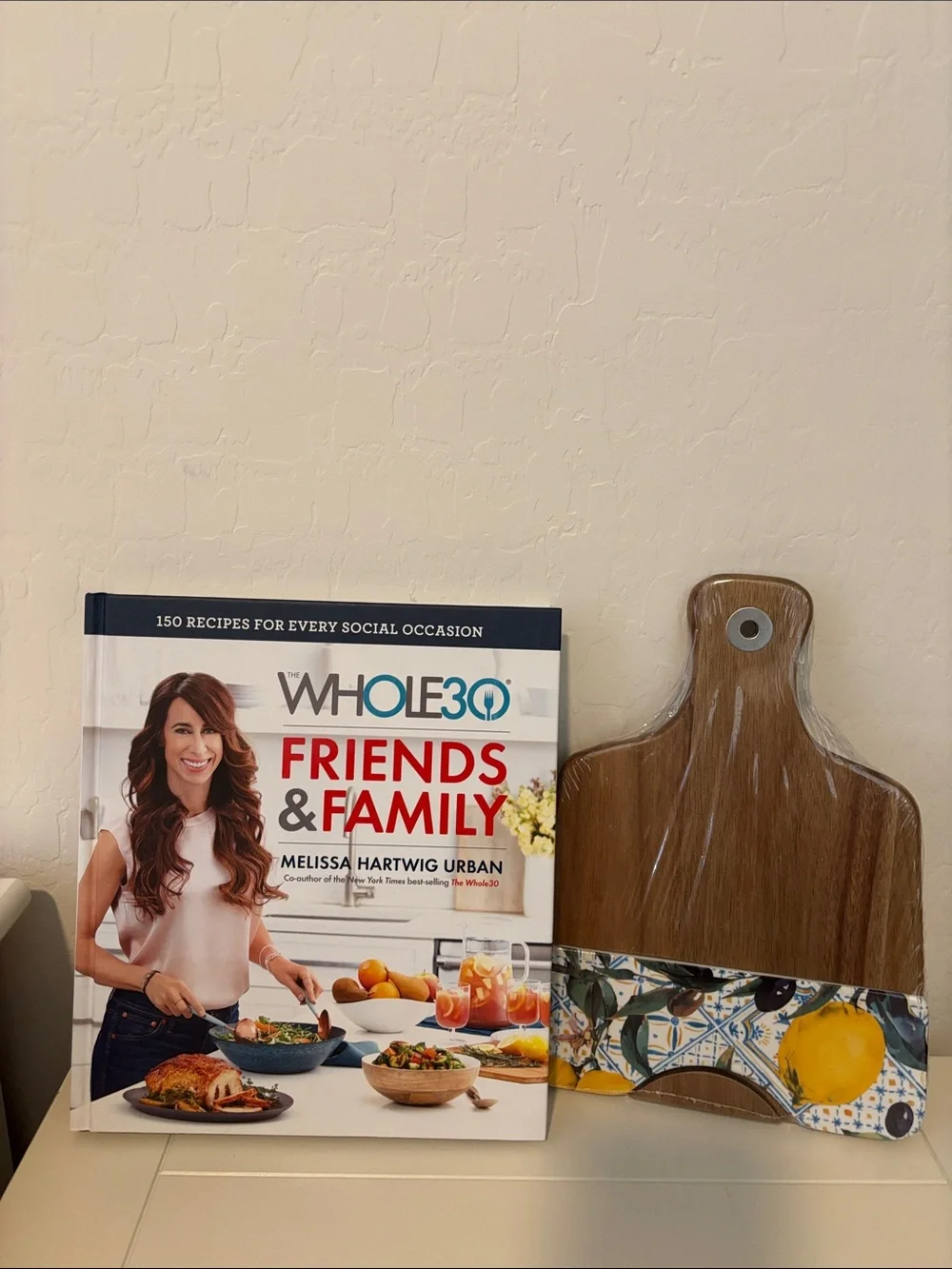 Friends & Family Cookbook & wooden cutting board.